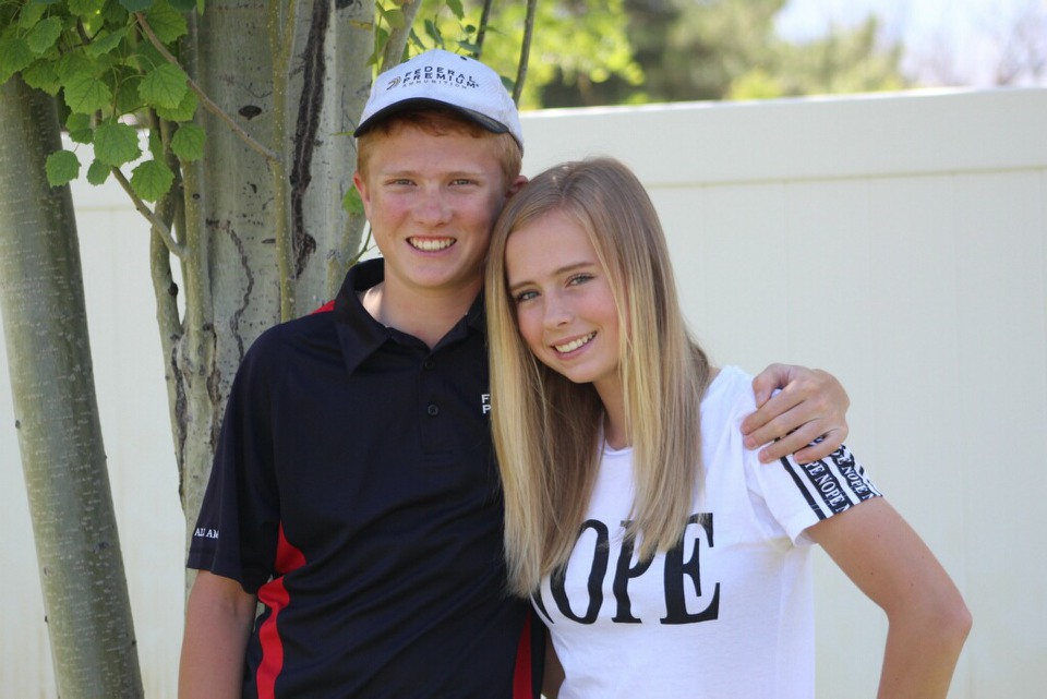 Grayson Stuart received a congratulatory hug from sister Saige after winning non-resident high gun in the Idaho Singles Championship.