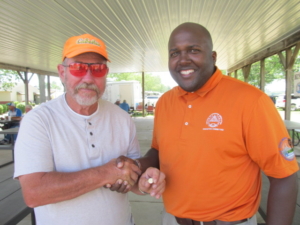 Bill Otter was presented his pin for reaching the 100,000 singles milestone by ATA Central Zone Vice President Darryl Hayes.